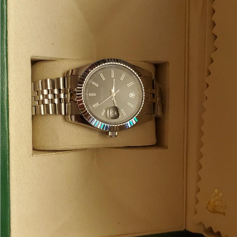 rolex silver timepiece with metallic bracelet